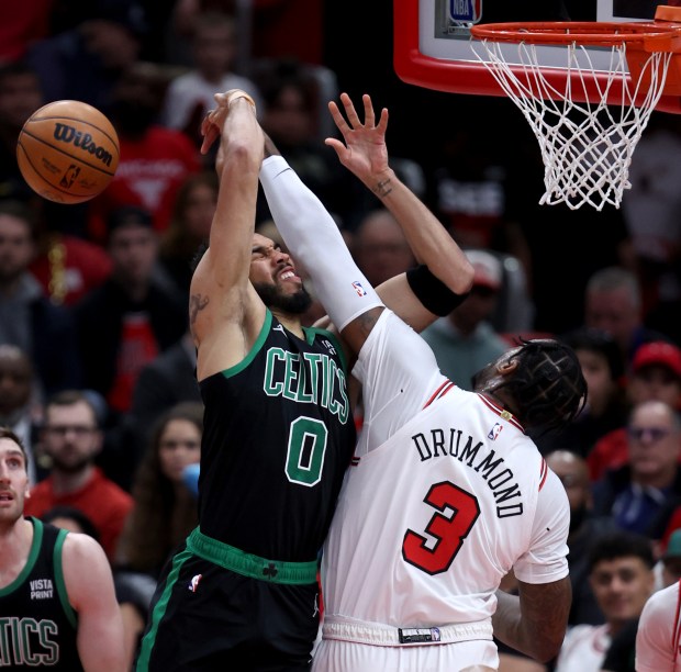 Bulls center Andre Drummond (3) blocks a shot by Celtics forward Jayson Tatum at the United Center on February 22, 2024. 