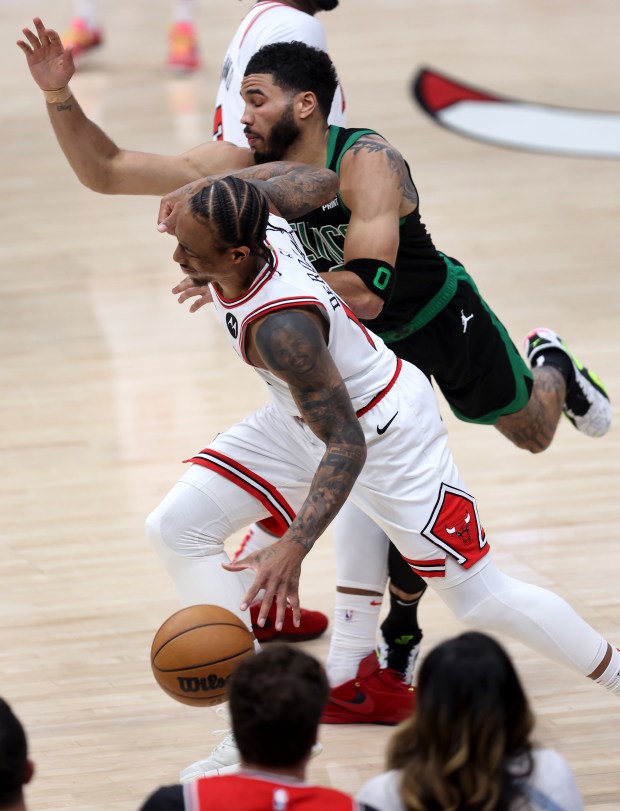 Celtics forward Jayson Tatum follows Bulls forward DeMar DeRozan on the sideline at the United Center on Feb. 22, 2024. 