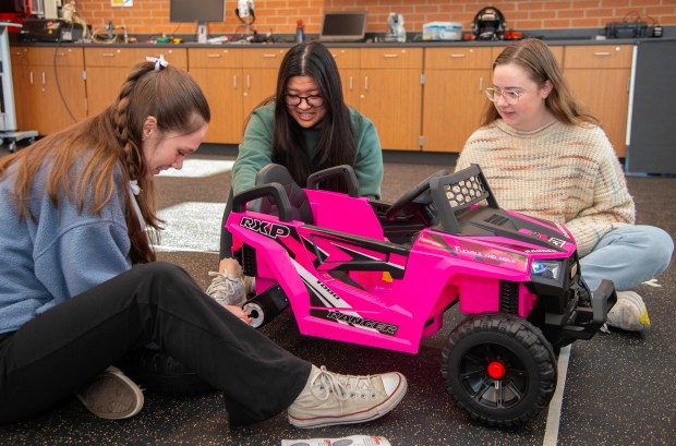 Valparaiso University biomedical engineering students Quinn Brothers (left), senior Abby Middleton (center) and senior Emma Lacey assemble a child's battery-powered vehicle to learn how it can be modified on Wednesday, Feb. 21, in the school's College of Engineering.  2024. (Michael Gard/Post-Tribune)