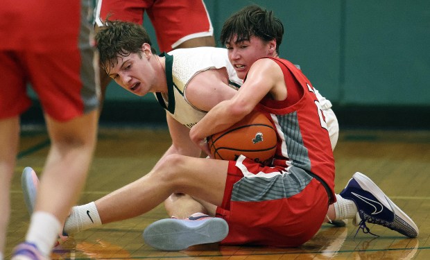 Aurora Christian's Jacob Baumann (22) beats St. Louis in a Chicagoland Christian Conference game on Tuesday, January 30, 2024 at Elgin.H.  Matthew wrestles the ball from Morrice (2) from Edward.  Rick Bamman / For Beacon News