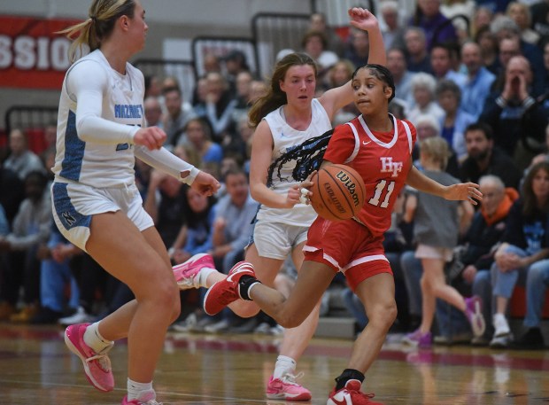 Homewood-Flossmoor's Layla Pierce (11) continues to dribble and waits for her teammates to catch up during the Class 4A Hinsdale Central Supersectional on Monday, Feb. 26, 2024, in Hinsdale, IL.  (For Steve Johnston/Daily Southtown)