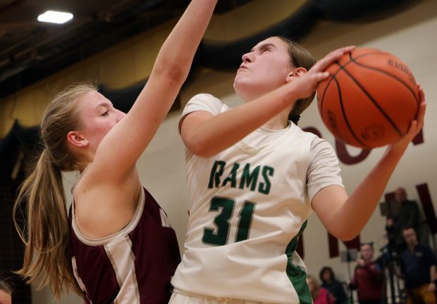 Grayslake Central's Peyton Hoffmann drives to the basket as Montini's Victoria Matulevicius defends during the Class 3A Concordia Supersectional on Monday, Feb. 26, 2024, in River Forest, Illinois.  (For James C. Svehla/New Sun)