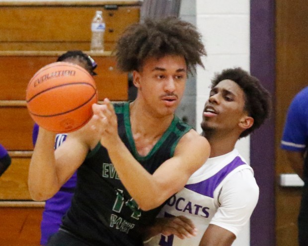 Evergreen Park's Tre Dowdell (left) hits Thornton's Meyoh Swansey (3) during the Class 3A Thornton Regional basketball semifinals on Tuesday, Feb. 27, 2024.  (John Smierciak for Daily Southtown)