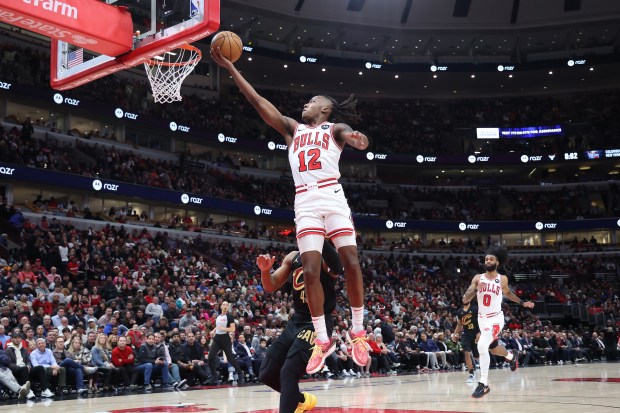 Bulls guard Ayo Dosunmu (12) rises toward the basket for an easy two points in the first half against the Cavaliers at the United Center in Chicago on Feb. 28, 2024.  (Terrence Antonio James/Chicago Tribune)
