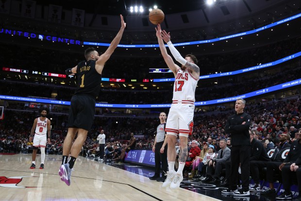 Bulls forward Onuralp Bitim (17) takes a shot off Cavaliers guard Max Strus (1) on defense in the first half at the United Center in Chicago on February 28, 2024.  (Terrence Antonio James/Chicago Tribune)