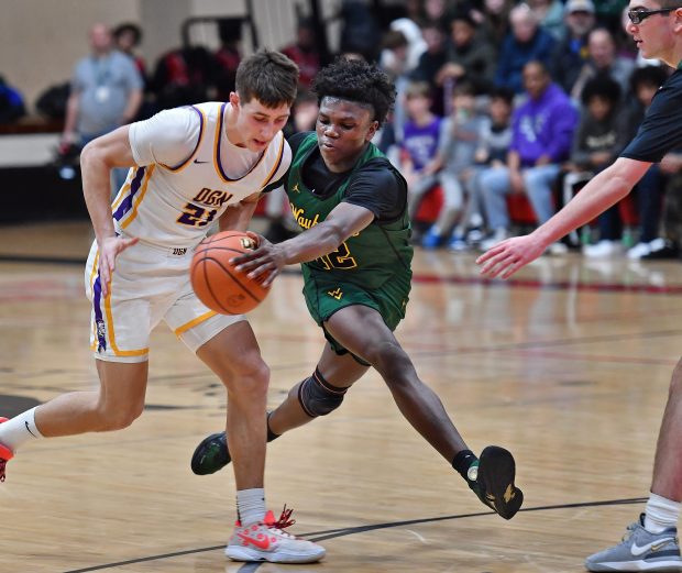 Waubonsie Valley's Tyreek Coleman clears the ball from Downers Grove North's Jack Stanton (21) during the Class 4A East Aurora Regional semifinal game in Aurora on Wednesday, Feb. 28, 2024. (Jon Cunningham for Naperville Sun)
