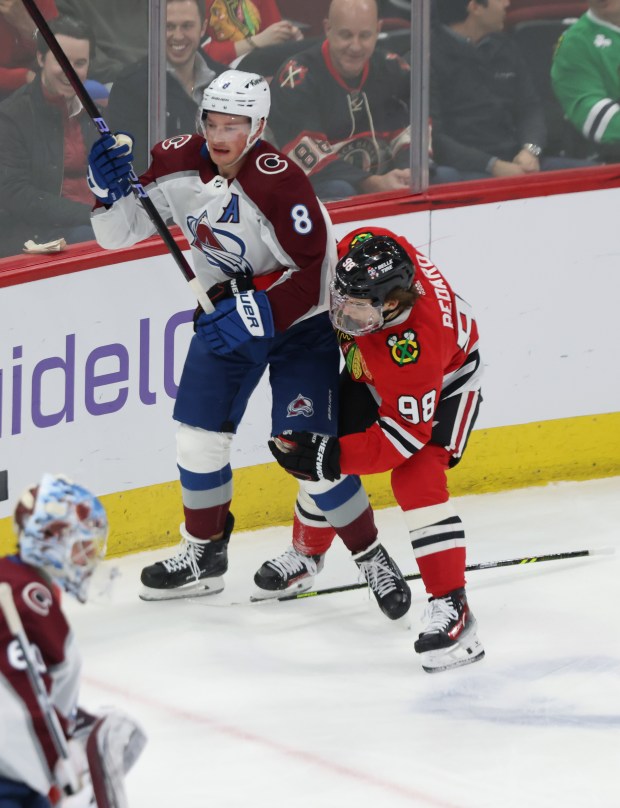 Blackhawks center Connor Bedard (98) loses his stick while making contact with Avalanche defenseman Cale Makar in the first period at the United Center on Feb. 29, 2024.  (John J. Kim/Chicago Tribune)