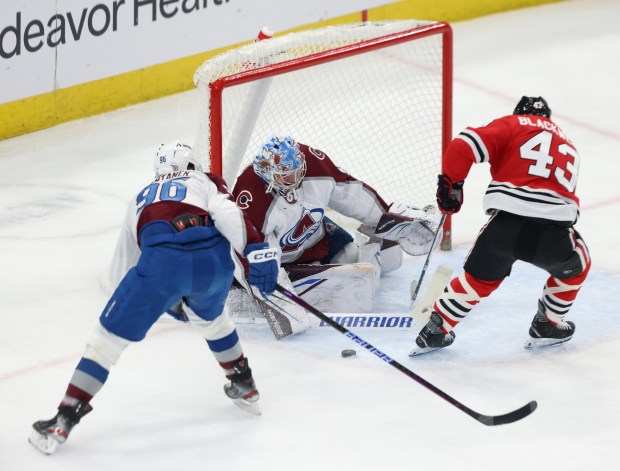 Avalanche goaltender Justus Annunen (60) deflects a shot on goal from Blackhawks center Colin Blackwell (43) in the first period at the United Center on Feb. 29, 2024.  (John J. Kim/Chicago Tribune)