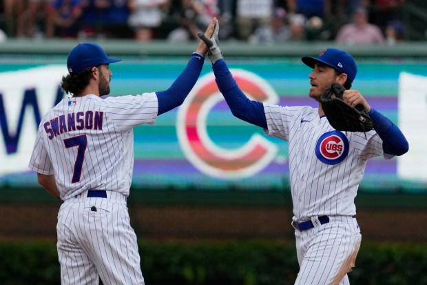 Chicago Cubs shortstop Dansby Swanson (left) celebrates with center fielder Cody Bellinger after defeating the Atlanta Braves during a baseball game Sunday, Aug. 6, 2023, in Chicago.  (Nam Y. Huh/AP)