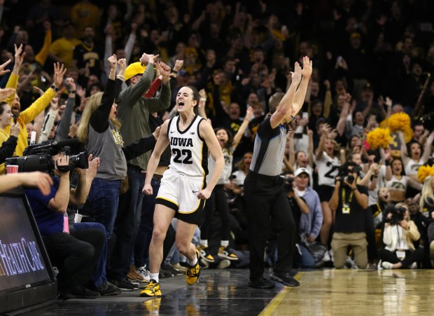 Iowa guard Caitlin Clark celebrates after breaking the NCAA women's all-time scoring record during a game against Michigan at Carver-Hawkeye Arena on February 15, 2024 in Iowa City, Iowa.  (Matthew Holst/Getty)