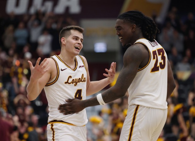 Loyola guard Braden Norris (4) gestures to teammate Philip Alston after making a 3-pointer in the second half against Dayton at Gentile Arena on March 1, 2024.  (John J. Kim/Chicago Tribune)