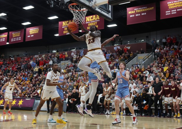 Loyola forward Philip Alston (23) makes a reverse layup in the second half against Dayton at Gentile Arena on March 1, 2024.  (John J. Kim/Chicago Tribune)