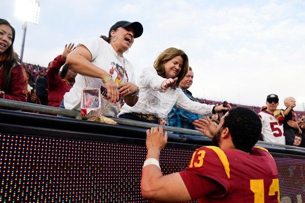 USC quarterback Caleb Williams (right) greets his mother Dayne Price (left) after the team's 38-20 loss to UCLA on Nov. 18, 2023, in Los Angeles.  (Ryan Sun/AP)