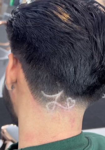 Elgin barber Emilio Chavez added a little twist to the back of his client's transformative haircut, as seen in a TikTok video.  (Emilio Chavez)