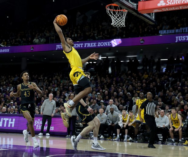 Iowa guard Tony Perkins (11) dunks in the second half against Northwestern at Welsh-Ryan Arena in Evanston on March 2, 2024.  (Chris Sweda/Chicago Tribune)