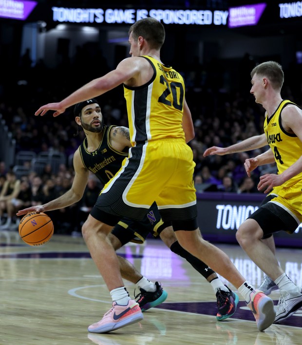 Northwestern guard Boo Buie (0) looks for an open teammate during the first half against Iowa on March 2, 2024 at Welsh-Ryan Arena in Evanston.  (Chris Sweda/Chicago Tribune)