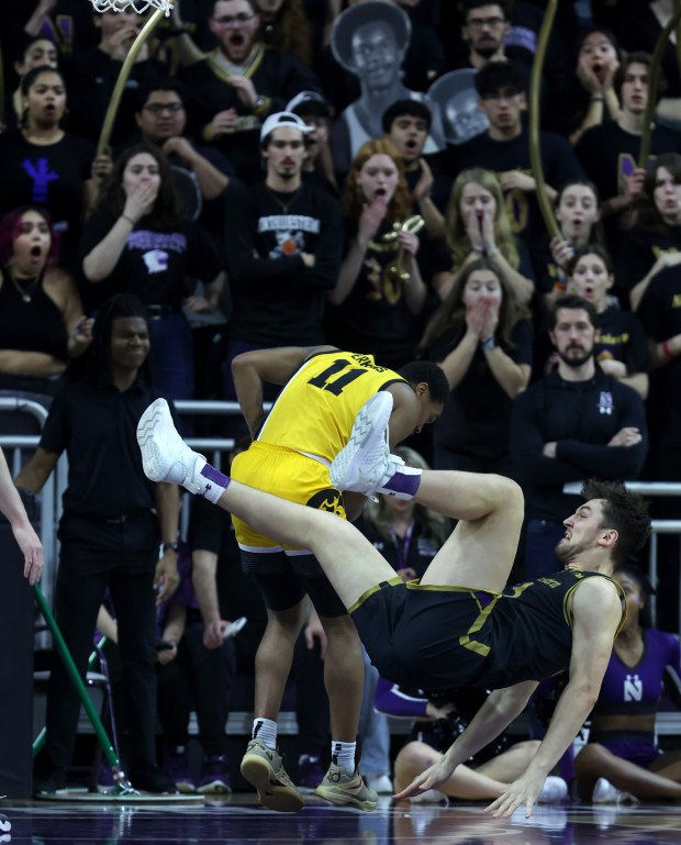 Northwestern forward Luke Hunger (33) goes down in the first half against Iowa on March 2, 2024, at Welsh-Ryan Arena in Evanston.  (Chris Sweda/Chicago Tribune)