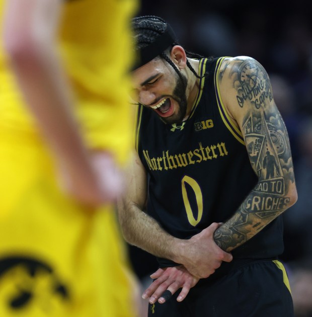 Northwestern guard Boo Buie (0) reacts after suffering an injury in the second half against Iowa on March 2, 2024 at Welsh-Ryan Arena in Evanston.  (Chris Sweda/Chicago Tribune)