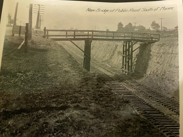 A wooden bridge crosses the newly excavated area "To cut" At Monee in this undated photo provided by the Monee Historical Society.  Railway project work was completed in 1923.  (Monee Historical Association)