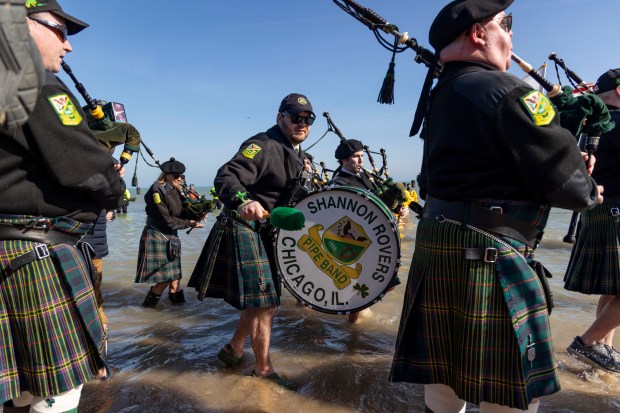 Shannon Rovers lead the parade as participants dive into Lake Michigan on a warm morning during the 24th Annual Chicago Polar Plunge at North Avenue Beach on Sunday, March 3, 2024.  (Brian Cassella/Chicago Tribune)