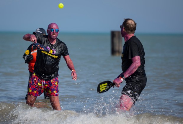 Participants play pickleball while diving into Lake Michigan on a warm morning during the 24th Annual Chicago Polar Plunge at North Avenue Beach on Sunday, March 3, 2024.  (Brian Cassella/Chicago Tribune)