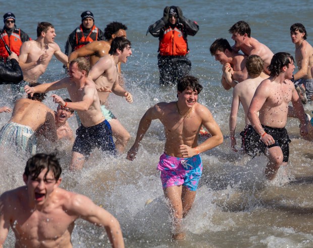Participants dive into Lake Michigan on a warm morning during the 24th Annual Chicago Polar Plunge on Sunday, March 3, 2024, at North Avenue Beach.  (Brian Cassella/Chicago Tribune)