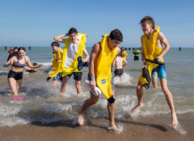Participants dressed as bananas dive into Lake Michigan on a warm morning during the 24th Annual Chicago Polar Plunge at North Avenue Beach on Sunday, March 3, 2024.  (Brian Cassella/Chicago Tribune)