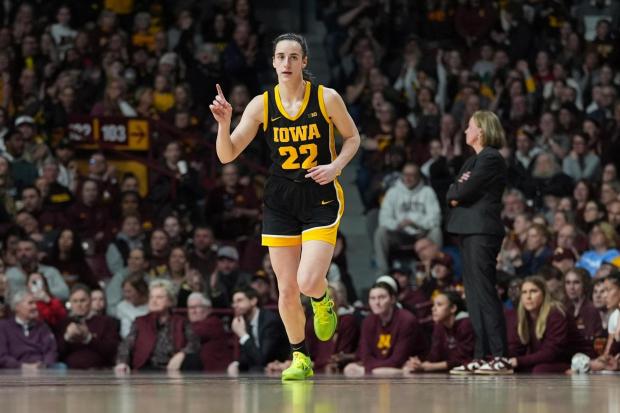 Iowa guard Caitlin Clark (22) scores after a basket by Iowa in the first half of the NCAA college basketball game against Minnesota on Wednesday, Feb. 28, 2024, in Minneapolis.  (AP Photo/Abbie Parr)
