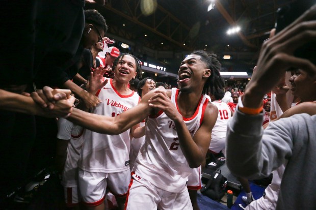 Homewood-Flossmoor guard Bryce Heard (2) celebrates with the rest of the Homewood-Flossmoor team after defeating Curie in the Class 4A UIC Supersectional on Monday, March 4, 2024, at Credit Union 1 Arena in Chicago.  (Trent Sprague/for the Daily) Southern town)
