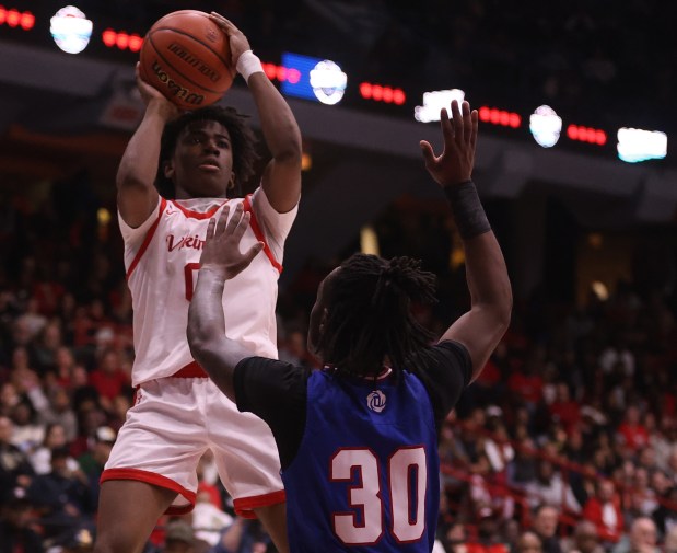 Homewood-Flossmoor point guard Jayden Tyler (0) makes a layup over the outstretched hands of Curie guard Mason Minor (30) during the Class 4A UIC Supersectional at Credit Union 1 Arena in Chicago on Monday, March 4, 2024.  (For Trent Sprague/Daily Southtown