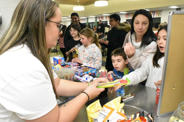 PTO volunteer Katie Smith works at the popular candy stand at Gower Middle School on Friday, March 1.  (Jesse Wright)