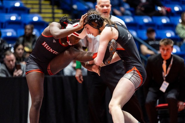 Angelina Gochis of Kaneland holds the leg of Huntley's Janiah Slaughter during their 105-pound girls wrestling championship match on Saturday, Feb. 24, 2024, at Grossinger Motors Arena in Bloomington.  (Vincent D. Johnson/Daily Southtown)