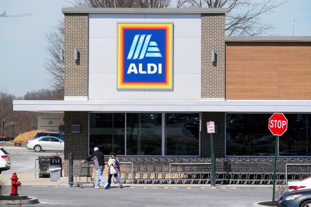 FILE - Customers enter an Aldi supermarket in Bensalem, Pa., on March 14, 2022.  Discount grocer Aldi plans to add 800 stores across the U.S. with a five-year expansion plan as it plans to capitalize on cost-conscious Americans feeling the pinch at grocery stores.  (AP Photo/Matt Rourke, File)