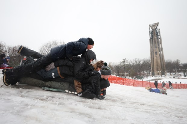 Sam Hayes, 14, Calum Baham, 15, Julian Thomas, 15, Blake Highhantes, 15, and Jack Libeo, 14, went sledding down Naperville's Rotary Park Sled Hill as a winter storm nearly hit the Chicago area. First they pile up on top of each other.  Snowstorm conditions on Friday, January 12, 2023.