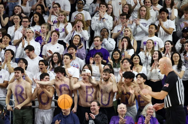 A group of Northwestern students writing their names in body paint "Boo Buie" He cheers after making a basket in the first half against Minnesota at Welsh-Ryan Arena in Evanston on March 9, 2024.  (John J. Kim/Chicago Tribune)