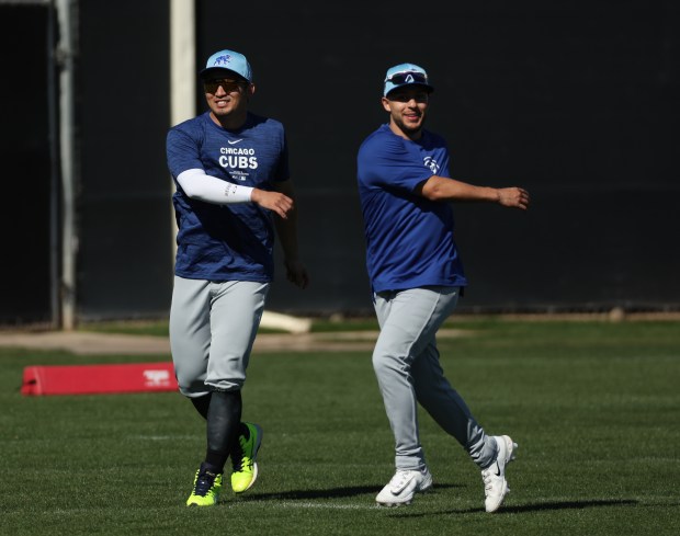 Cubs outfielder Seiya Suzuki (left) and infielder Nick Madrigal warm up in Mesa, Ariz., on February 22, 2024 (Stacey Wescott/Chicago Tribune)