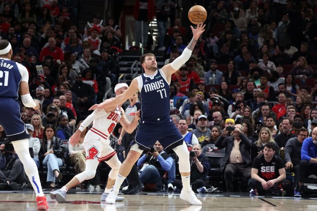 Bulls guard Alex Caruso (6) defends while catching a pass from Mavericks guard Luka Doncic (77) in the first half at the United Center in Chicago on March 11, 2024.  (Terrence Antonio James/Chicago Tribune)