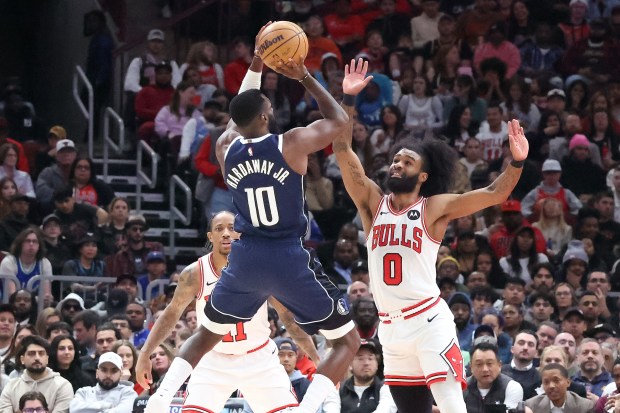 Mavericks forward Tim Hardaway Jr.  (10) shoots past Bulls guard Coby White (0) in the first half at the United Center in Chicago on March 11, 2024.  (Terrence Antonio James/Chicago Tribune)