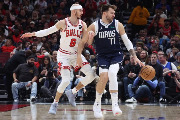 Bulls guard Alex Caruso (6) reacts to a spin move by Mavericks guard Luka Doncic (77) in the first half at the United Center in Chicago on March 11, 2024.  (Terrence Antonio James/Chicago Tribune)
