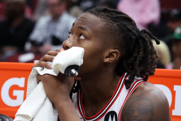 Bulls guard Ayo Dosunmu (12) watches from the bench during the second half of the game against the Mavericks at the United Center in Chicago on March 11, 2024.  (Terrence Antonio James/Chicago Tribune)