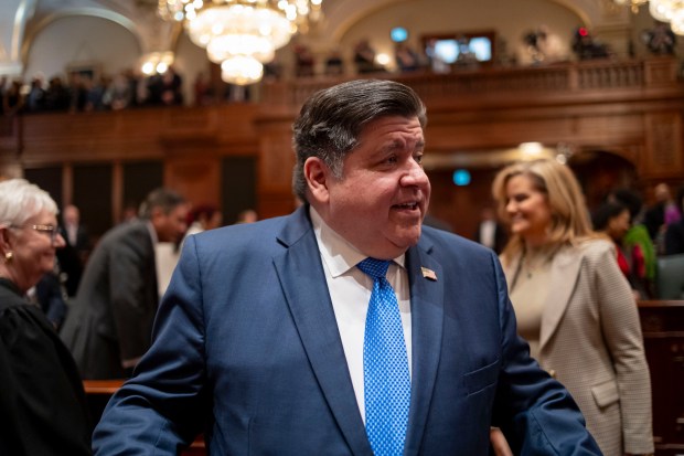 Governor JB Pritzker greets lawmakers as he arrives to deliver his State of the State and budget address before the General Assembly at the Illinois State Capitol on Wednesday, Feb. 21, 2024.  (Brian Cassella/Chicago Tribune/pool)