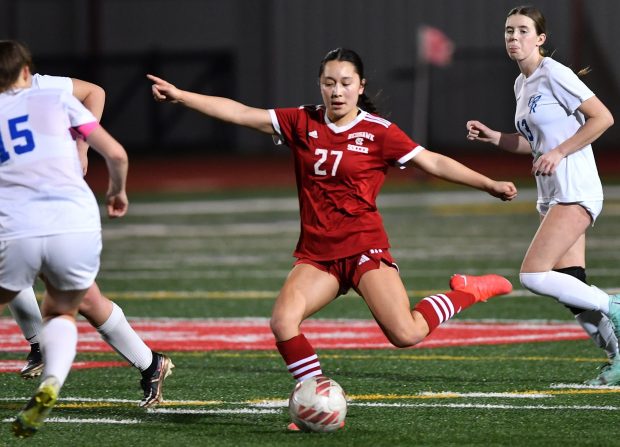 Naperville Central's Malia Shen (27) takes a shot while surrounded by Burlington Central defenders during a game in Naperville on Wednesday, March 13, 2024.(Jon Cunningham/For The Naperville Sun)